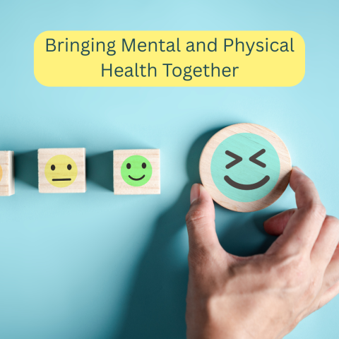 Image of a hand holding a circular block with a smiling face. One yellow wooden block with a face that is not smiling. One wooden block with a small smile. Blue Background. Text that reads Bringing Mental and Physical Health Together. Yellow rectangle.