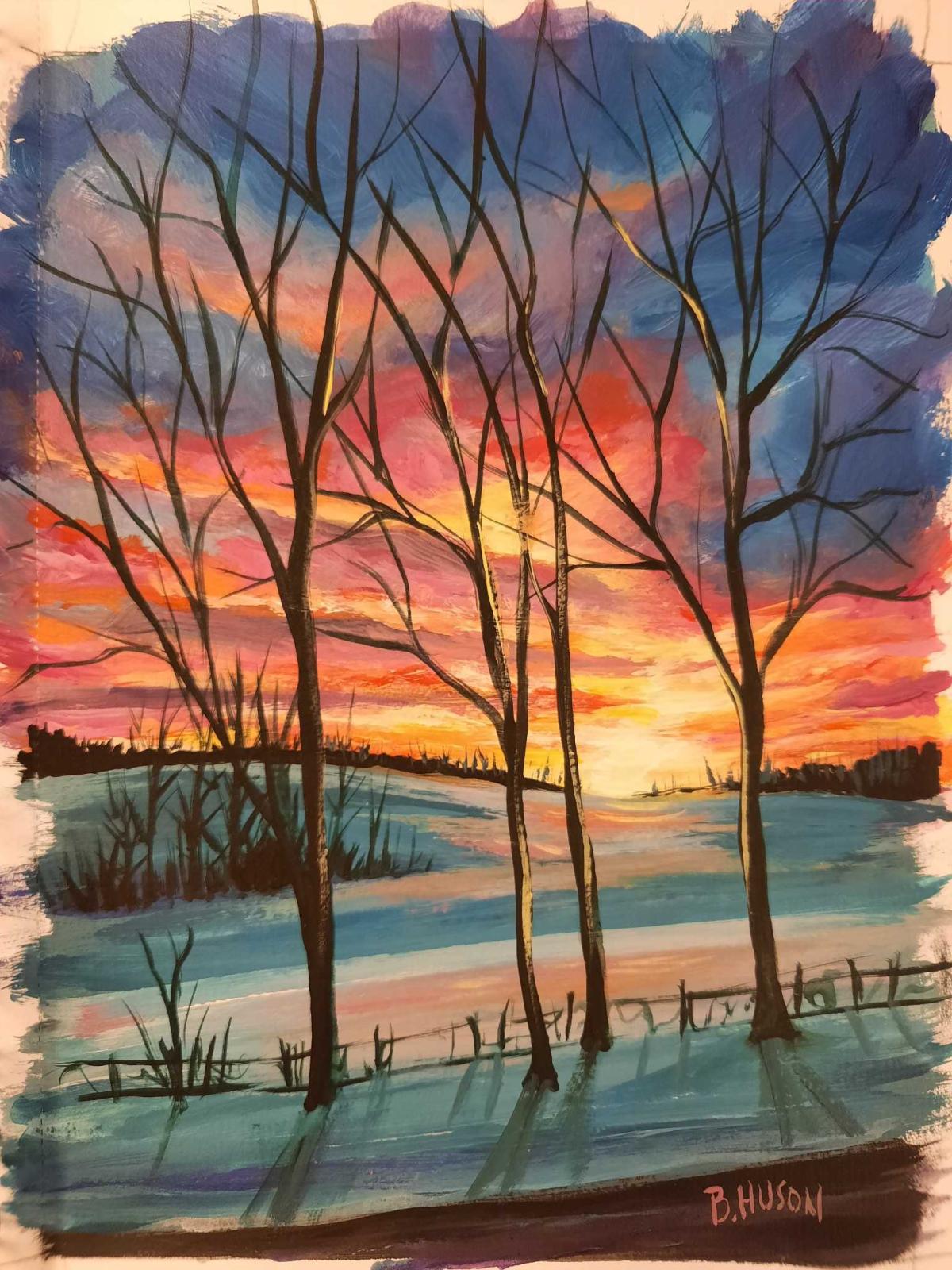 sunset on a snowy background with large barren trees